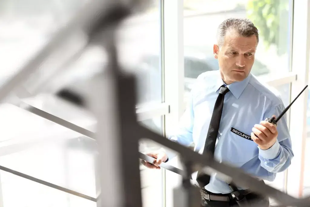 the security guard holding a walkie talkie